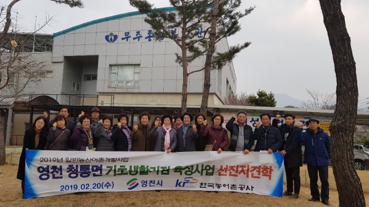 견학 일정을 마치고 복지관 앞에서 현수막 들고 단체사진(현수막: 2019년 일반농산어촌개발사업 영천 청통면 기초생활거점육성사업 선진지견학)